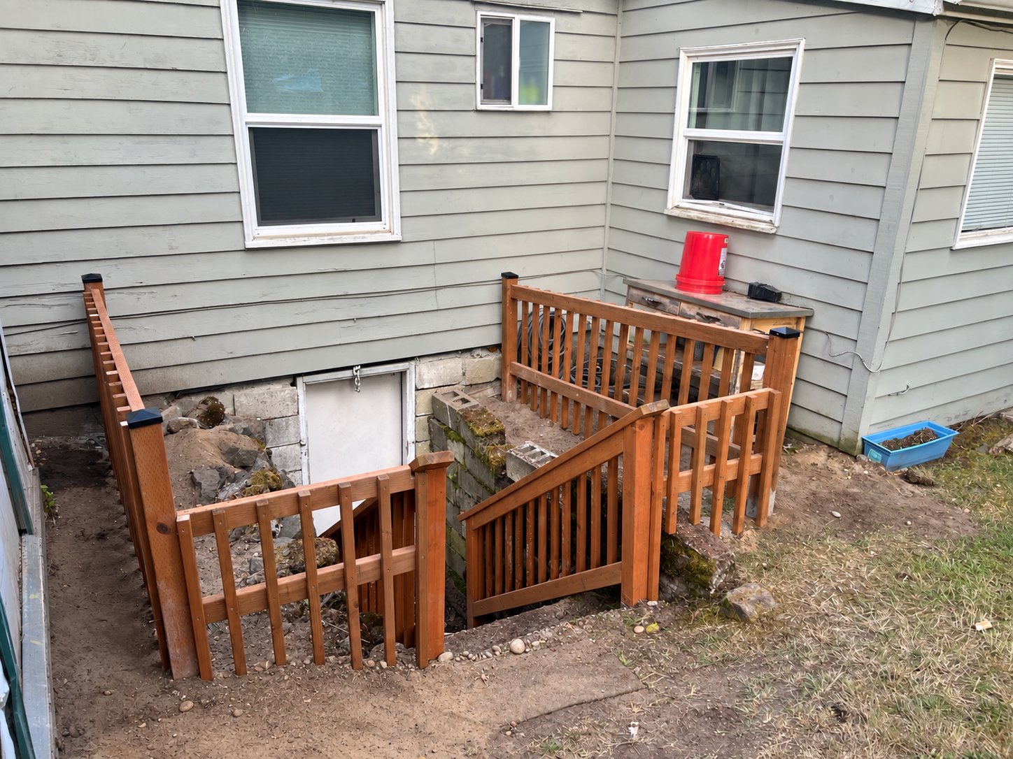 Basement stairwell after new wooden railing was installed